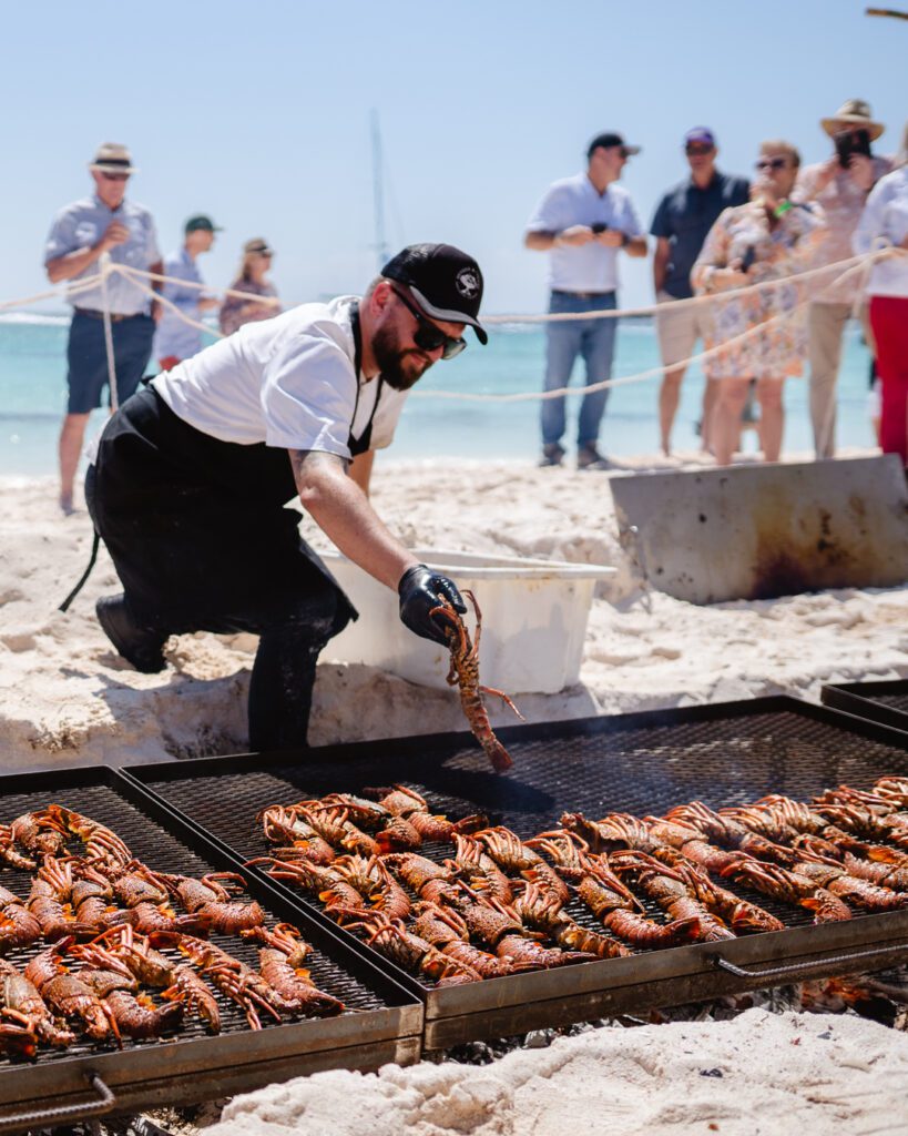 Shore Leave Festival 2022 Chef places seafood on a grill